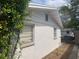 A textured exterior with white siding and green landscaping at 7519 Kensico Dr, Port Richey, FL 34668