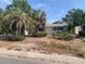 Single story home with a lawn featuring mature palms and a traditional, symmetrical facade at 7519 Kensico Dr, Port Richey, FL 34668