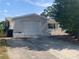 A one car garage with ample parking space on a sunny day at 7519 Kensico Dr, Port Richey, FL 34668