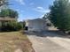 A one car garage with ample parking space on a sunny day at 7519 Kensico Dr, Port Richey, FL 34668