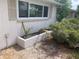 Small planting box under a window with arid landscaping at 7519 Kensico Dr, Port Richey, FL 34668