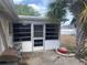 An enclosed screen patio featuring a BBQ grill at 7519 Kensico Dr, Port Richey, FL 34668