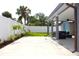 View of backyard featuring covered patio, white fence, and manicured grass at 7909 Woodgrove Cir, Tampa, FL 33615
