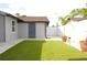 Backyard with artificial turf, a shed and white vinyl fencing at 7909 Woodgrove Cir, Tampa, FL 33615