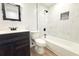 Bathroom featuring a dark vanity, mirror, white tile, and toilet at 7909 Woodgrove Cir, Tampa, FL 33615