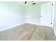 Bedroom featuring wood-look flooring and a white ceiling fan at 7909 Woodgrove Cir, Tampa, FL 33615