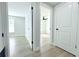 View of the open bedroom featuring wood-look flooring and white painted walls at 7909 Woodgrove Cir, Tampa, FL 33615