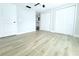 Bedroom featuring wood-look flooring and two closets and view into bathroom at 7909 Woodgrove Cir, Tampa, FL 33615