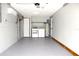 Clean garage area with washer, dryer, water heater, and epoxy floors at 7909 Woodgrove Cir, Tampa, FL 33615