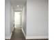 Neutral hallway featuring wood-look flooring and updated doors at 7909 Woodgrove Cir, Tampa, FL 33615