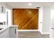 Kitchen area showcasing wood paneling and modern flooring at 7909 Woodgrove Cir, Tampa, FL 33615