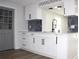Kitchen featuring white cabinetry, marble backsplash, and stainless faucet at 7909 Woodgrove Cir, Tampa, FL 33615