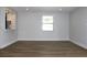 Open living room featuring updated floors and natural light at 7909 Woodgrove Cir, Tampa, FL 33615