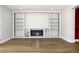 Living room featuring built-in shelving and fireplace at 7909 Woodgrove Cir, Tampa, FL 33615