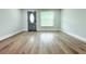 Open-concept living room features stylish laminate flooring and fresh light grey paint at 7909 Woodgrove Cir, Tampa, FL 33615