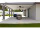 Wide angle view of the covered patio with outdoor dining and lounge spaces at 7909 Woodgrove Cir, Tampa, FL 33615