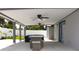 Wide angle view of covered patio with ceiling fans and patio furniture at 7909 Woodgrove Cir, Tampa, FL 33615