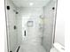 Walk-in shower featuring light stone patterned tile and unique shelving system at 7909 Woodgrove Cir, Tampa, FL 33615