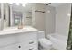 Bright bathroom features white vanity, toilet, and tiled tub/shower, offering a clean and functional space at 8198 Terrace Garden Dr # 511, St Petersburg, FL 33709