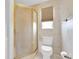 Shower stall and standard toilet in bathroom with textured walls at 8198 Terrace Garden Dr # 511, St Petersburg, FL 33709