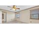 Neutral bedroom featuring carpeted floors, ceiling fan, windows with blinds and ensuite bathroom access at 8198 Terrace Garden Dr # 511, St Petersburg, FL 33709