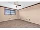 Bedroom featuring carpeted floors, ceiling fan, and a large window with blinds at 8198 Terrace Garden Dr # 511, St Petersburg, FL 33709