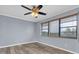 Bedroom featuring laminate floors, neutral paint and window with wood blinds at 8198 Terrace Garden Dr # 511, St Petersburg, FL 33709