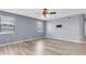 Spacious bedroom boasts stylish flooring, a ceiling fan, and natural light, complete with a wall-mounted TV bracket at 8198 Terrace Garden Dr # 511, St Petersburg, FL 33709