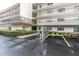 Exterior view showcasing the building entrance and covered parking with mature landscaping around the property at 8198 Terrace Garden Dr # 511, St Petersburg, FL 33709