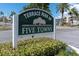 Terrace Park of Five Towns community sign with lush landscaping and palm trees on a sunny day at 8198 Terrace Garden Dr # 511, St Petersburg, FL 33709