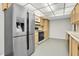 Kitchen with stainless steel refrigerator and oak cabinets, offers ample storage at 8198 Terrace Garden Dr # 511, St Petersburg, FL 33709