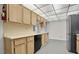 Kitchen with oak cabinets, laminate countertops and black dishwasher at 8198 Terrace Garden Dr # 511, St Petersburg, FL 33709