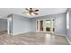 Light-filled living room with stylish wood flooring and a ceiling fan, creating a comfortable atmosphere at 8198 Terrace Garden Dr # 511, St Petersburg, FL 33709