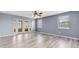 Inviting living room featuring modern flooring, a ceiling fan, and large windows for ample natural light at 8198 Terrace Garden Dr # 511, St Petersburg, FL 33709