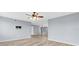 Spacious living room featuring wood floors and a modern ceiling fan fixture at 8198 Terrace Garden Dr # 511, St Petersburg, FL 33709