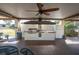 Covered outdoor kitchen equipped with a grill, sink, and refrigerator, ideal for outdoor cooking and dining at 8198 Terrace Garden Dr # 511, St Petersburg, FL 33709