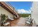 Rooftop deck featuring outdoor seating with stairs leading up to deck and scenic treetop views at 8198 Terrace Garden Dr # 511, St Petersburg, FL 33709