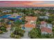 Aerial view of beautiful beach neighborhood, showing the home's pool, rooftop deck and tile roof at 831 Mandalay Ave, Clearwater, FL 33767