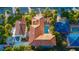 Aerial view of a home with an orange tile roof, a rooftop patio, and a backyard pool at 831 Mandalay Ave, Clearwater, FL 33767