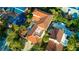 A stunning aerial view showcasing the pool, sun deck, and terracotta roof tiles at 831 Mandalay Ave, Clearwater, FL 33767