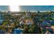Aerial view of a neighborhood with a sandy beach and a waterway in the background at 831 Mandalay Ave, Clearwater, FL 33767