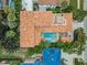Aerial view showcasing a home's red tile roof, pool, and outdoor living spaces at 831 Mandalay Ave, Clearwater, FL 33767