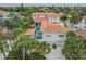 Aerial view of a home with an orange tile roof, a rooftop patio, and a backyard pool at 831 Mandalay Ave, Clearwater, FL 33767