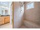 Features a tiled walk-in shower with a built-in bench and neutral color palette, complemented by natural light at 831 Mandalay Ave, Clearwater, FL 33767