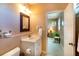 Bright bathroom featuring a vanity, toilet, mirror, and doorway to a bedroom at 831 Mandalay Ave, Clearwater, FL 33767