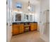 Elegant bathroom with dual sinks, granite countertops, vanity area, and modern lighting fixtures at 831 Mandalay Ave, Clearwater, FL 33767