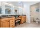 Luxurious bathroom with dual sinks, granite counters, vanity, and modern, lit mirrors at 831 Mandalay Ave, Clearwater, FL 33767