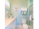Well-lit bathroom with a vanity, toilet, mermaid art, and a glass-enclosed shower at 831 Mandalay Ave, Clearwater, FL 33767