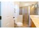 Bathroom with a glass enclosed shower and a toilet with a closed white door to the left at 831 Mandalay Ave, Clearwater, FL 33767
