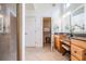 Bright bathroom featuring dual sinks, vanity, granite counters, tiled floor, and access to the shower and closet at 831 Mandalay Ave, Clearwater, FL 33767